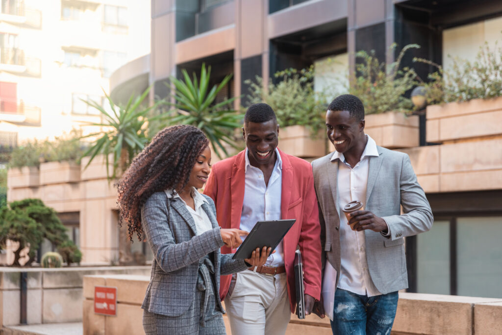 A sales professional having a direct customer engagement with two male customers.