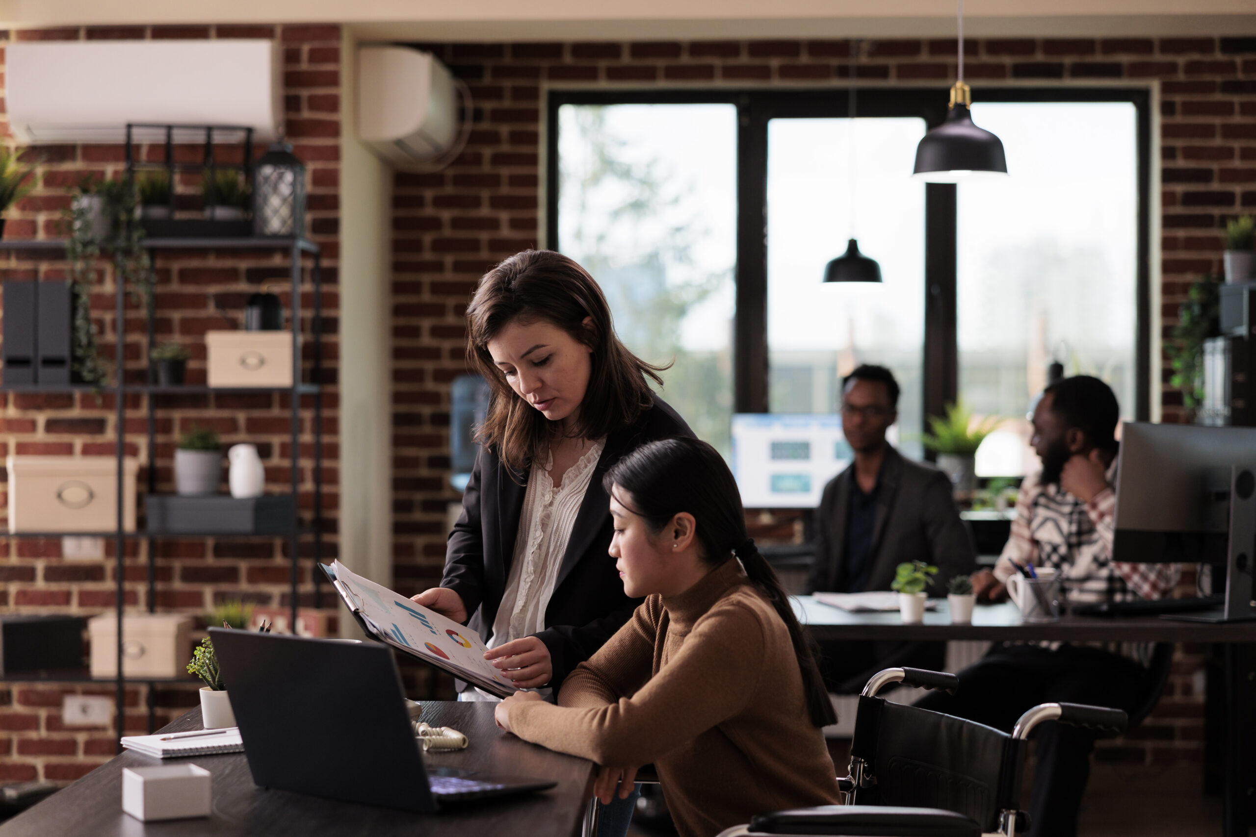 A manager giving a career mentorship to her team member in the office.